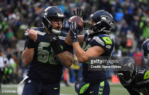 Tight end Luke Willson of the Seattle Seahawks celebrates with center Justin Britt after scoring a touchdown during the fourth quarter of the game...
