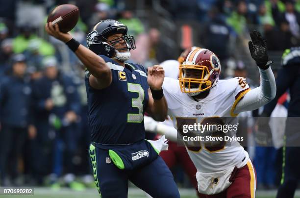 Quarterback Russell Wilson of the Seattle Seahawks is pressured by inside linebacker Zach Brown of the Washington Redskins during the second quarter...