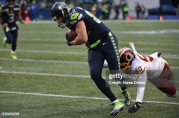 Tight end Luke Willson of the Seattle Seahawks avoids the tackle of inside linebacker Zach Brown of the Washington Redskins scoring a touchdown...