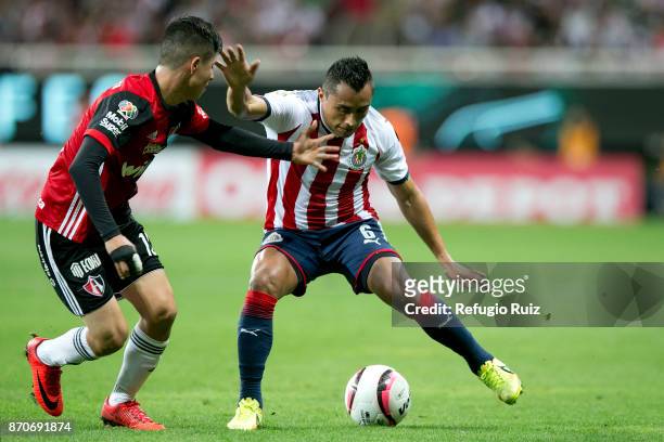Edwin Hernandez of Chivas fights for the ball with Javier Salas of Atlas during the 16th round match between Chivas and Atlas as part of the Torneo...