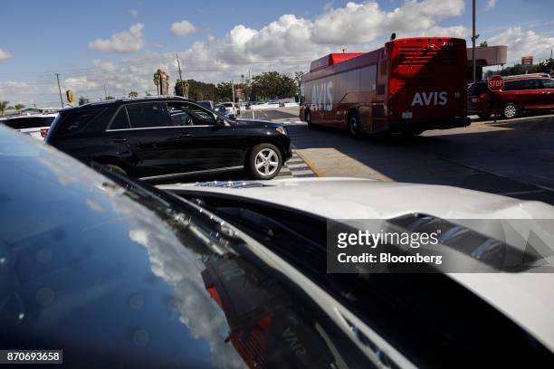 Shuttle bus drives past rental vehicles at an Avis Budget Group Inc. Location at Los Angeles International Airport in Los Angeles, California, U.S.,...