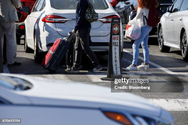 Customers return a rental vehicle at an Avis Budget Group Inc. Location at Los Angeles International Airport in Los Angeles, California, U.S., on...