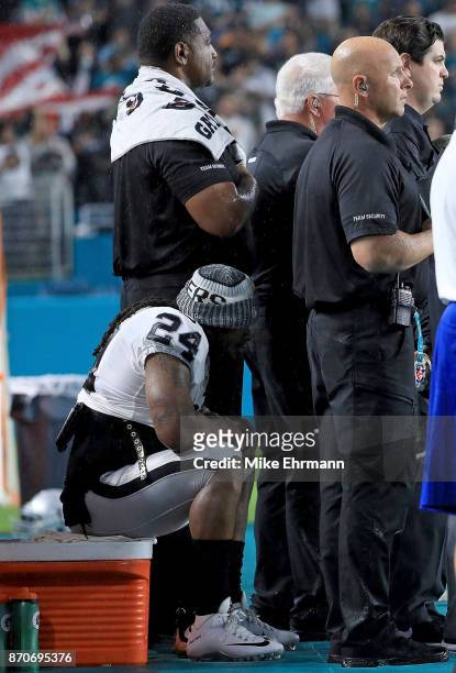 Marshawn Lynch of the Oakland Raiders sits during the national anthem during a game against the Miami Dolphins at Hard Rock Stadium on November 5,...