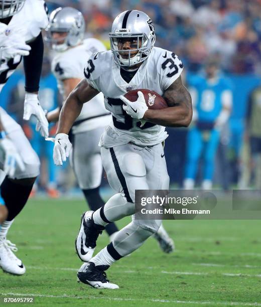 DeAndre Washington of the Oakland Raiders rushes during a game against the Miami Dolphins at Hard Rock Stadium on November 5, 2017 in Miami Gardens,...