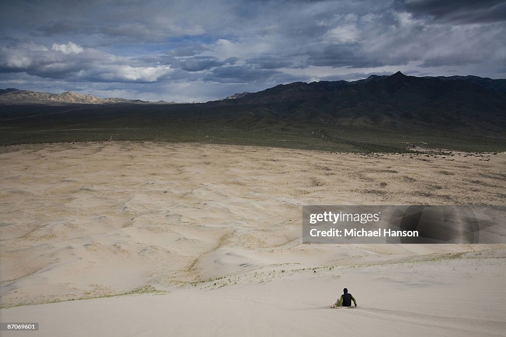 A man slides down the sand dunes in Mojave Desert, California.