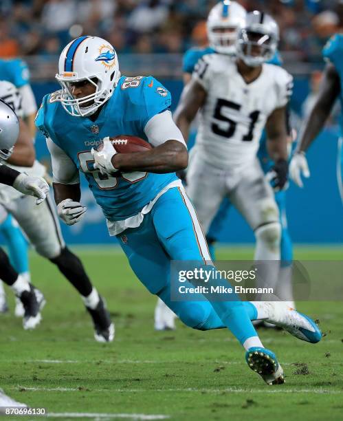 Julius Thomas of the Miami Dolphins runs after a catch during a game against the Oakland Raiders at Hard Rock Stadium on November 5, 2017 in Miami...