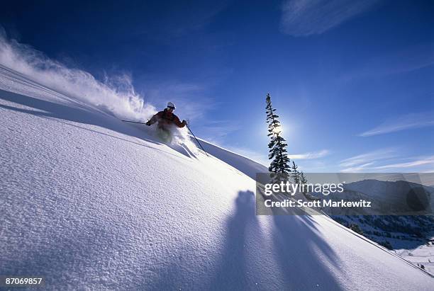 man skiing deep powder in utah. - alta stock-fotos und bilder