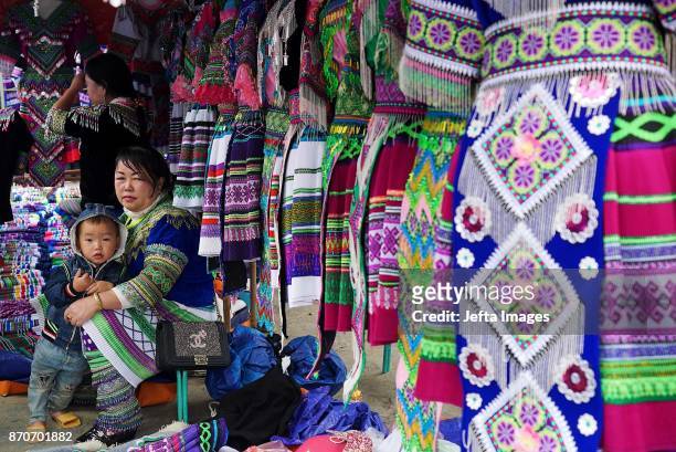Ethnic Hmong women selling tourist souvenirs at the mountainous Bac Ha weekly Sunday market in the northern Vietnamese province of Lao Cai, on...