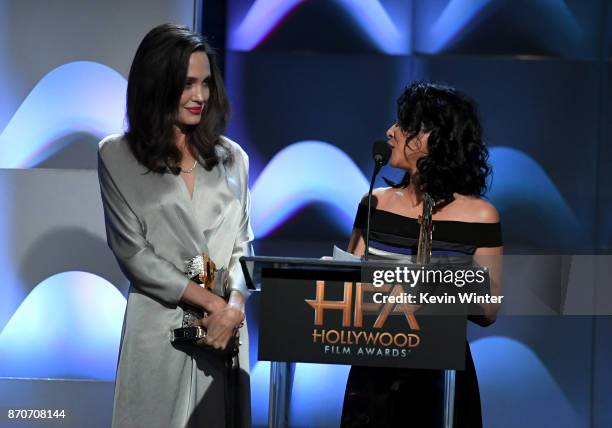 Honorees Angelina Jolie and Loung Ung accept the Hollywood Foreign Language Film Award for 'First They Killed My Father' onstage during the 21st...