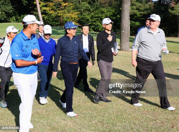 President Donald Trump , Japanese Prime Minister Shinzo Abe and professional golfer Hideki Matsuyama walk at Kasumigaseki Country Club in Kawagoe,...