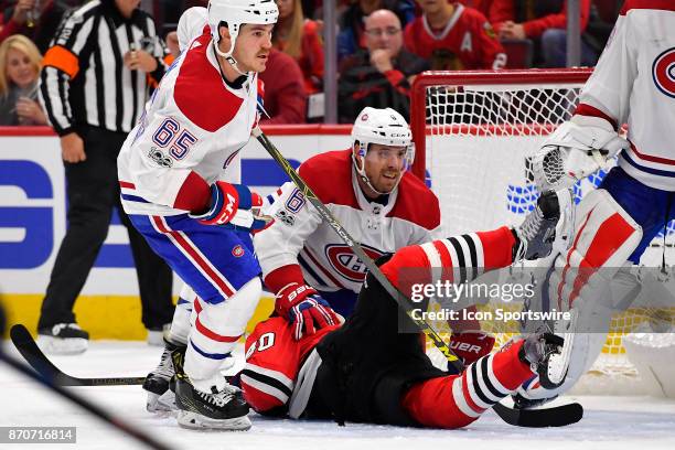 Montreal Canadiens defenseman Shea Weber falls on top of Chicago Blackhawks right wing John Hayden near the goal during the game between the Montreal...