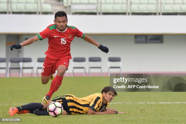 Saddil Ramdani of Indonesia vies for the ball with Muhammad Akhyar Abdul Rashid of Malaysia during their AFC U-19 Championship 2018 qualifying round...