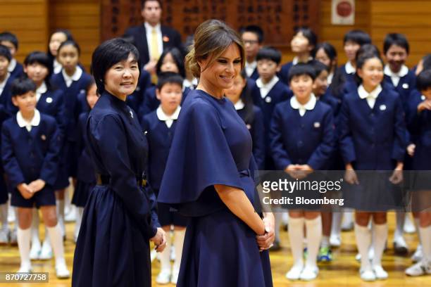 First Lady Melania Trump, center, stands with Akie Abe, wife of Japan's Prime Minister Shinzo Abe, left, during a visit to Kyobashi Tsukiji...