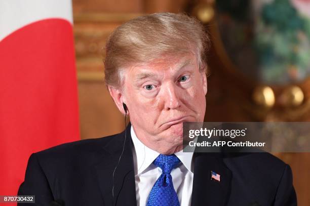 President Donald Trump gestures during a joint press conference with Japanese Prime Minister Shinzo Abe at Akasaka Palace in Tokyo on November 6,...