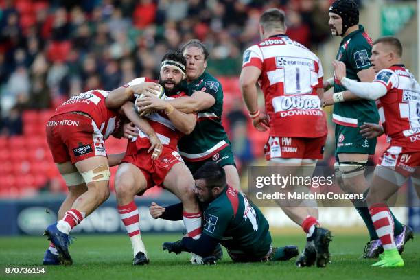 James Hanson of Gloucester Rugby is tackled by Pat Cilliers of Leicester Tigers during the Anglo-Welsh Cup tie between Leicester Tigers and...