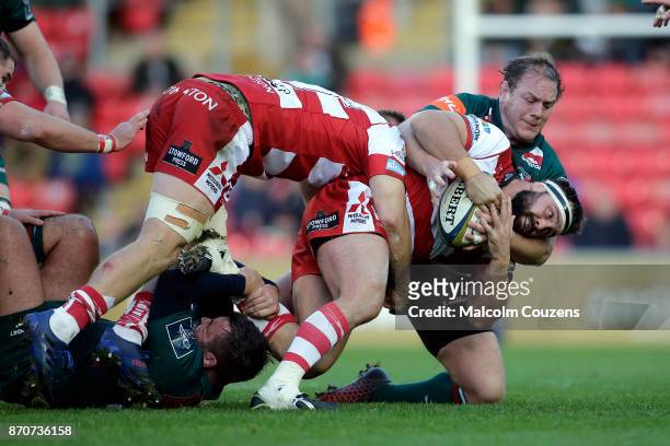 James Hanson of Gloucester Rugby is tackled by Pat Cilliers of Leicester Tigers during the Anglo-Welsh Cup tie between Leicester Tigers and...