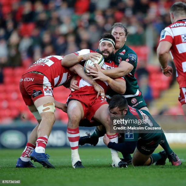 James Hanson of Gloucester Rugby is tackled by Pat Cilliers of Leicester Tigers during the Anglo-Welsh Cup tie between Leicester Tigers and...