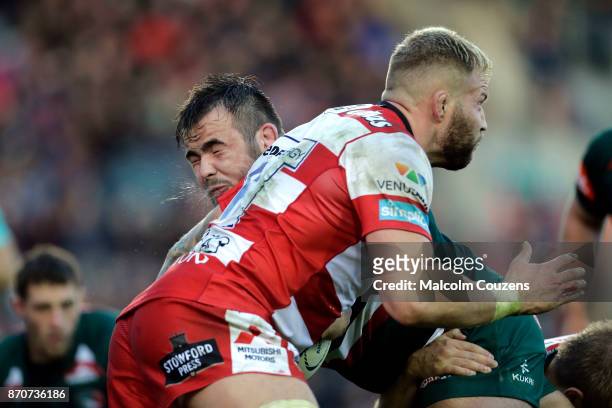 George McGuigan of Leicester Tigers collides with Ross Moriarty of Gloucester Rugby during the Anglo-Welsh Cup tie between Leicester Tigers and...