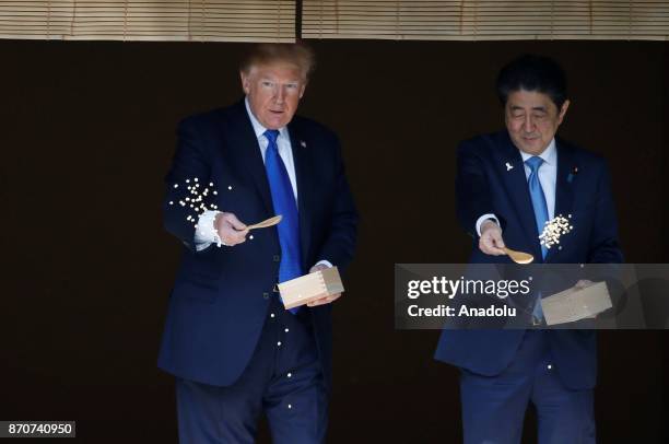 President Donald Trump and Japanese Prime Minister Shinzo Abe feed carps before their working lunch at Akasaka Palace in Tokyo, Japan on November 6,...