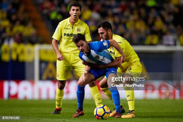 Juanpi of Malaga CF competes for the ball with Victor Ruiz of Villarreal CF during the La Liga match between Villarreal CF and Malaga CF at Estadio...