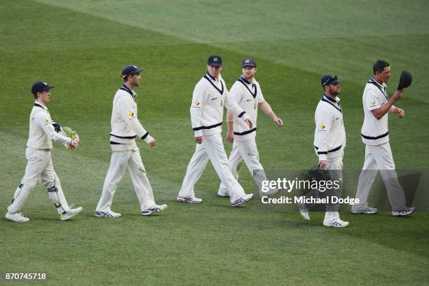 Victorian players walk off after a long day in the field during day three of the Sheffield Shield match between Victoria and South Australia at...