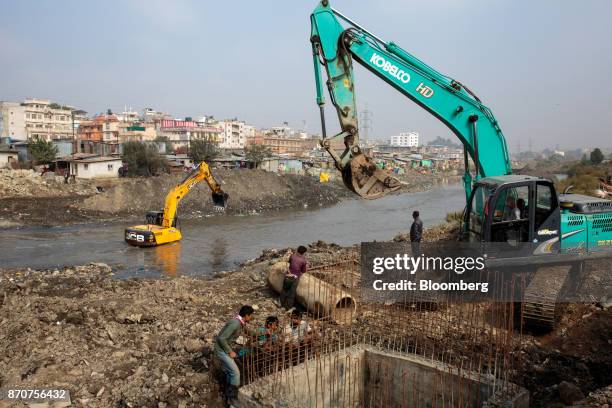 Excavators operate at a construction site along the Bagmati River in Kathmandu, Nepal, on Wednesday, Nov. 1, 2017. India and China have often jostled...