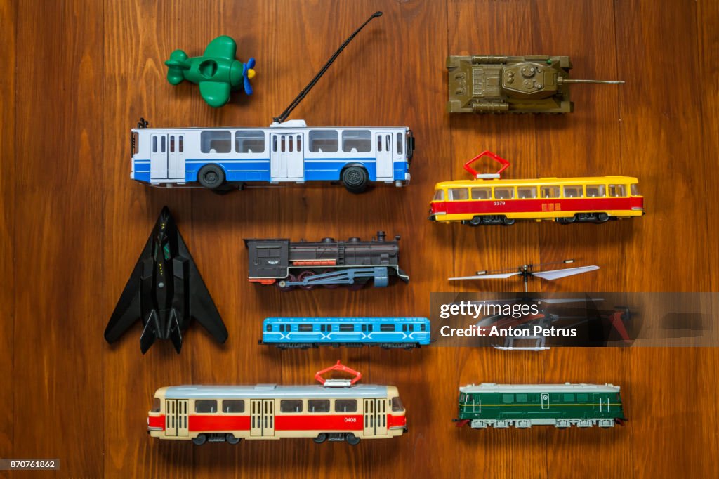 Different toy transport on a wooden background.Knolling style shot.