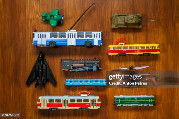 different toy transport on a wooden background.knolling style shot. - toy helicopter stock pictures, royalty-free photos & images