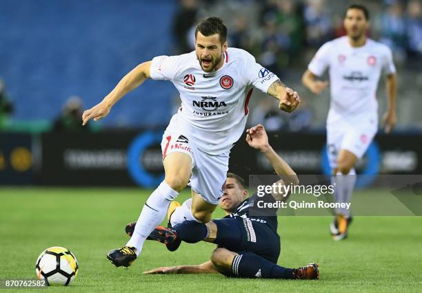 Brendan Hamill of the Wanderers is tackled by Mitchell Austin of the Victory during the round five A-League match between the Melbourne Victory and...