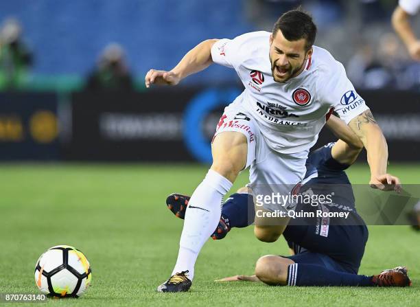 Brendan Hamill of the Wanderers is tackled by Mitchell Austin of the Victory during the round five A-League match between the Melbourne Victory and...
