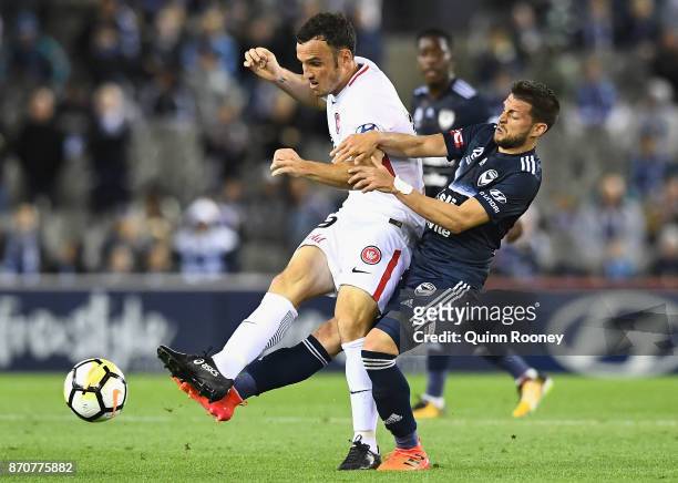 Mark Bridge of the Wanderers and Matias Sanchez of the Victory compete for the ball during the round five A-League match between the Melbourne...