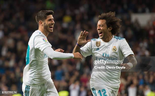 Marco Asensio of Real Madrid CF celebrates with Marcelo after scoring his teamÕs 2nd goal during the La Liga match between Real Madrid and Las Palmas...