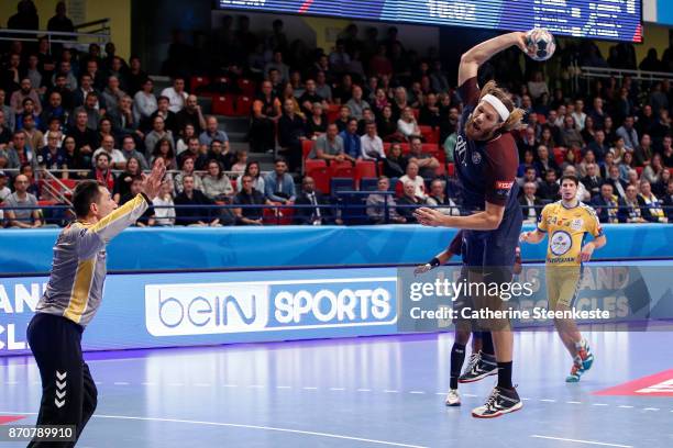 Mikkel Hansen of Paris Saint Germain is shooting the ball against Slawomir Szmal of PGE Vive Kielce during the Champions League match between Paris...