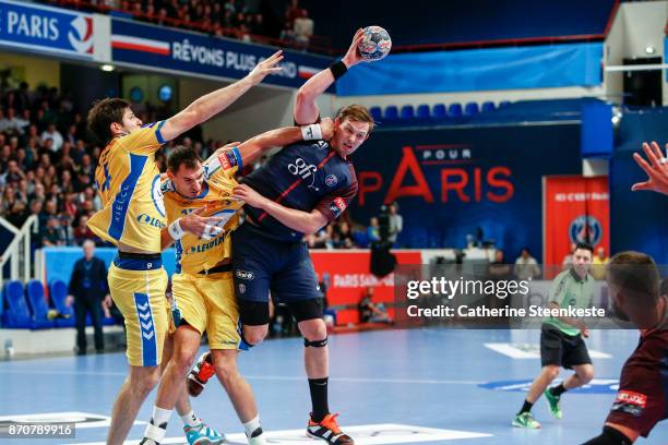 Sander Sagosen of Paris Saint Germain is trying to pass the ball against Krzysztof Lijewski and Marko Mamic of PGE Vive Kielce during the Champions...