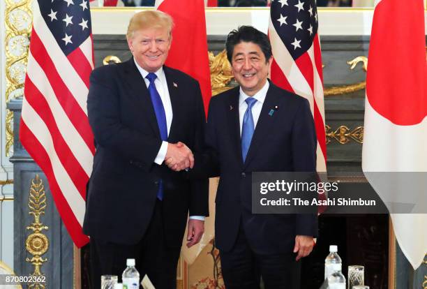 President Donald Trump and Japanese Prime Minister Shinzo Abe shake hands prior to their meeting at the Akasaka State Guest House on November 6, 2017...