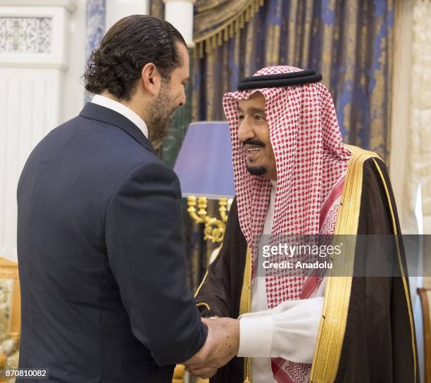 King of Saudi Arabia Salman bin Abdulaziz Al Saud shakes hands with Former Prime Minister of Lebanon Saad Hariri , who resigned recently, at Palace...