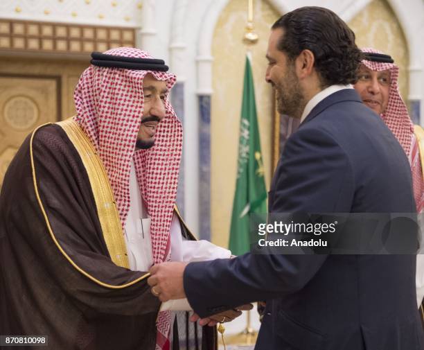 King of Saudi Arabia Salman bin Abdulaziz Al Saud shakes hands with Former Prime Minister of Lebanon Saad Hariri , who resigned recently, at Palace...