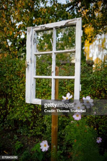 Berlin, Germany An old window stands as a decoration in a garden on October 17, 2017 in Berlin, Germany.