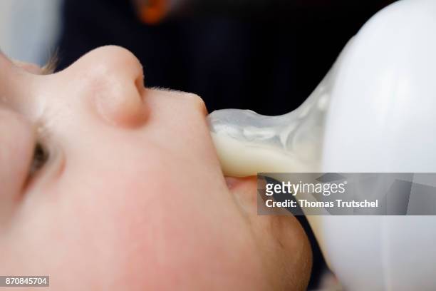 An infant drinks milk from a bottle on October 17, 2017 in Berlin, Germany.