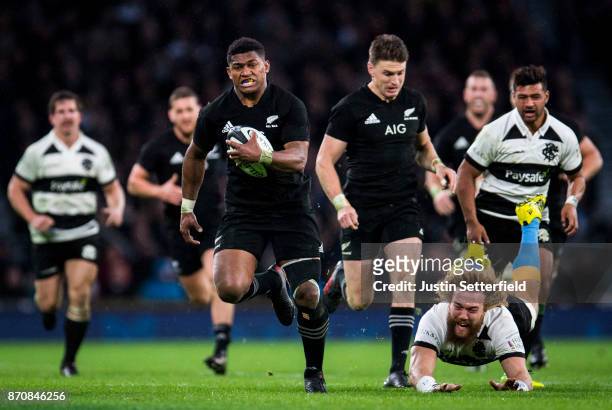 Waisake Naholo of New Zealand evades the tackle of Willie Britz of Barbarians during the Killik Cup between Barbarians and New Zealand at Twickenham...