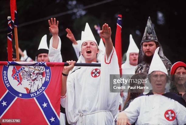 Supporters of the Ku Klux Klan salute as they gather to march May 4 Stone Mountain, Georgia