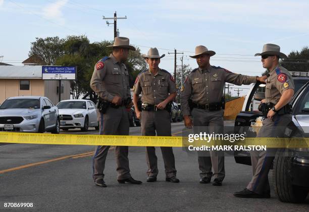 State troopers guard the entrance to the First Baptist Church after a mass shooting that killed 26 people in Sutherland Springs, Texas on November 6,...
