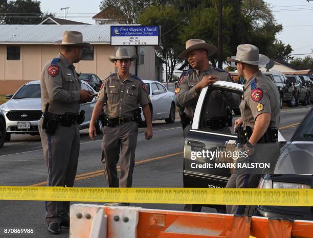 State troopers guard the entrance to the First Baptist Church after a mass shooting that killed 26 people in Sutherland Springs, Texas on November 6,...