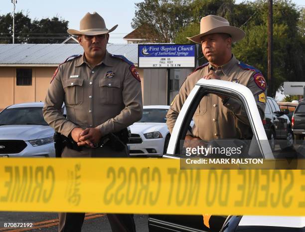 State troopers guard the entrance to the First Baptist Church after a mass shooting that killed 26 people in Sutherland Springs, Texas on November 6,...