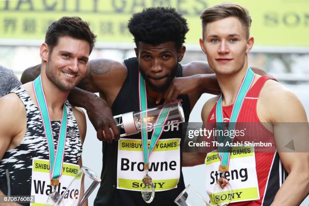 Paralympic sprinters Jarryd Wallace of the United States, Richard Browne of the United States, and Felix Streng of Germany pose for photographs...