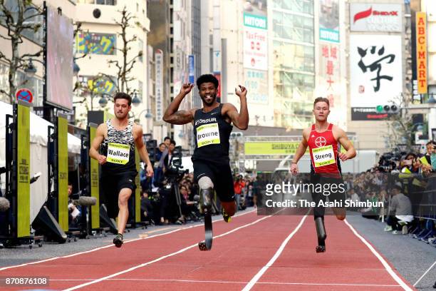 Paralympic sprinters Jarryd Wallace of the United States, Richard Browne of the United States, and Felix Streng of Germany comepte during the Shibuya...