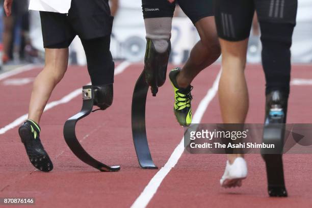 Paralympic sprinters Jarryd Wallace of the United States, Richard Browne of the United States, and Felix Streng of Germany pose for photographs...