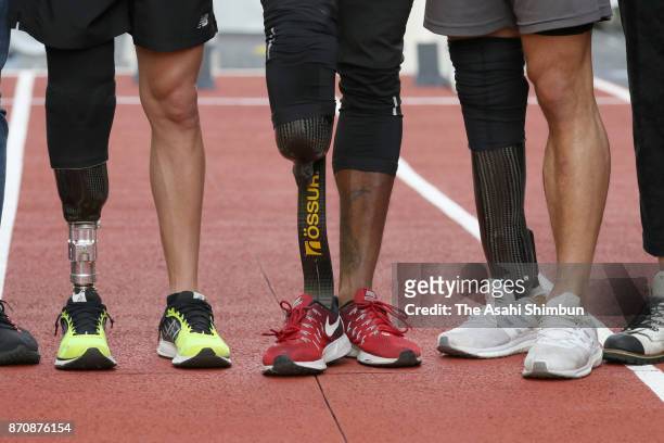 Paralympic sprinters Jarryd Wallace of the United States, Richard Browne of the United States, and Felix Streng of Germany pose for photographs...