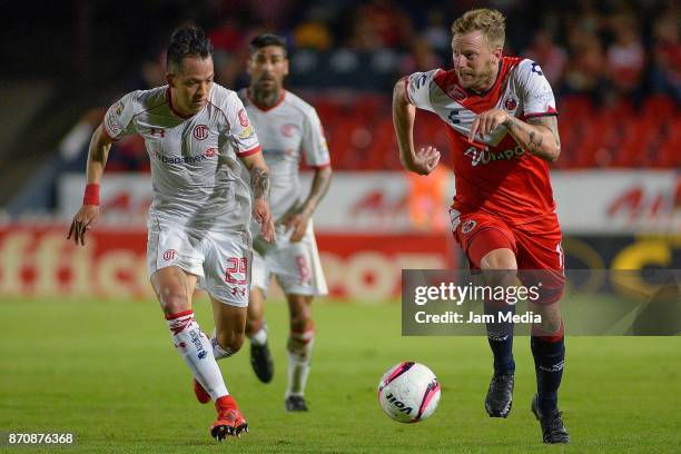 Cristian Menendez of Veracruz and Rodrigo Salinas of Toluca run for the ball during the 16th round match between Veracruz and Toluca as part of the...