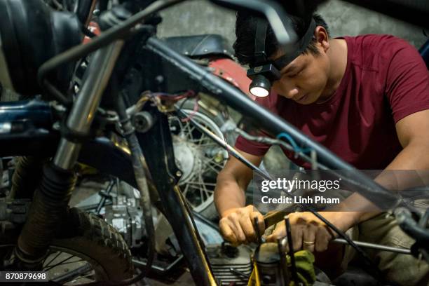 Pham Ngoc Thach a Minsk motorcycle enthusiast turned into professional engineer, fine-tunes his own Minsk motorcycle in preparation for an off-road...